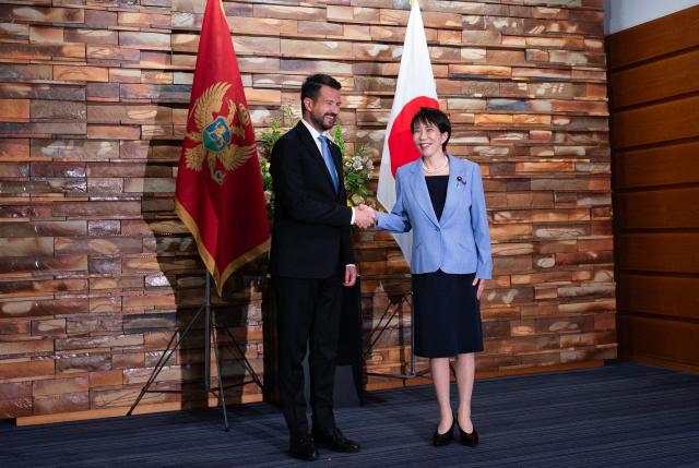 Japan's Prime Minister Sanae Takaichi (R) shakes hands with Montenegro's President Jakov Milatovic (L) before a meeting at the prime minister's office in Tokyo on April 22, 2026. (Photo by Andrew CABALLERO-REYNOLDS / AFP)