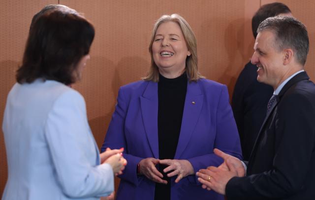 German Minister for Labour and Social Affairs Baerbel Bas (C) talks with German Minister for Research, Technology and Aerospace Dorothee Baer (L) and Chief of Staff and Minister for Special Tasks Thorsten Frei (R) prior to the weekly cabinet meeting at the Chancellery in Berlin on April 22, 2026. (Photo by Odd ANDERSEN / AFP)