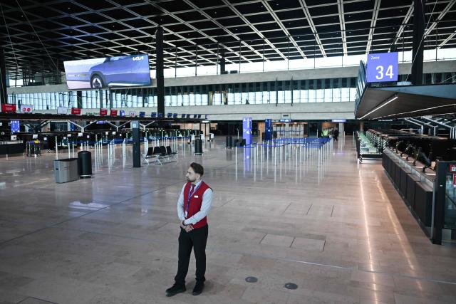 A man stands at the check-in counters at the Terminal 3 at the Frankfurt International airport on the day of the official inauguration of new Terminal 3 on April 22, 2026 in Frankfurt, western Germany. (Photo by Kirill KUDRYAVTSEV / AFP)