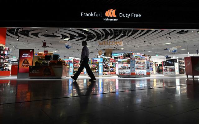 A person walks past  the Heineman duty free shop inside the new Terminal 3 of Frankfurt's international airport on the day of its official inauguration on April 22, 2026 in Frankfurt, western Germany. (Photo by Kirill KUDRYAVTSEV / AFP)