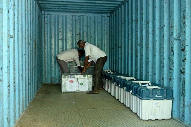 Election officials load polling materials onto a truck before they are dispatched to polling stations on the eve of the 2026 Tamil Nadu Legislative Assembly elections in Chennai on April 22, 2026. (Photo by R. Satish BABU / AFP)