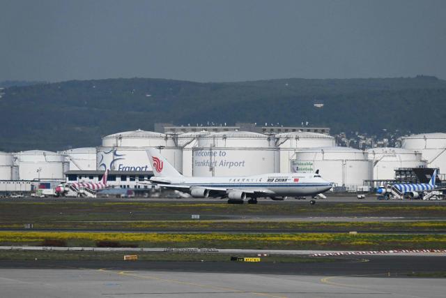 An aircraft of Air China is pictured in front of Oil tanks at the Frankfurt International airport on the day of the official inauguration of new Terminal 3 on April 22, 2026 in Frankfurt, western Germany. (Photo by Kirill KUDRYAVTSEV / AFP)