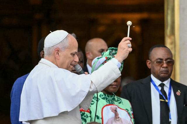 Pope Leo XIV blesses the first stone for the new church as he arrives to lead a Holy Mass at the Basilica of the Immaculate Conception in Mongomo on the tenth day of an 11-day apostolic journey to Africa, on April 22, 2026. (Photo by Alberto PIZZOLI / AFP)