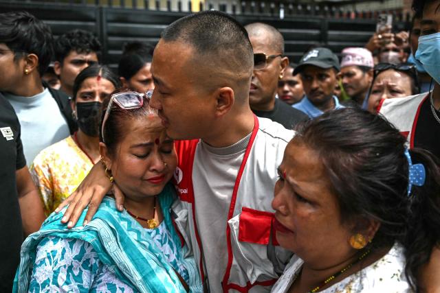 (FILES) Sudan Gurung (C), a key figure among the Gen Z protesters, meets with family members of a victim, who died during anti-corruption clashes with security personnel, outside the Tribhuvan University Teaching Hospital in Kathmandu on September 13, 2025. Nepal's under-fire home minister Sudan Gurung resigned on April 22, 2026, he said in a social media post. (Photo by Arun SANKAR / AFP)