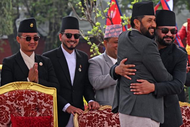 (FILES) Nepal's newly sworn-in home minister Sudan Gurung (L) gestures as prime minister Balendra Shah (R) embraces his Rastriya Swatantra Party's president Rabi Lamichhane (2R) during their swearing-in ceremony in Kathmandu on March 27, 2026. Nepal's under-fire home minister Sudan Gurung resigned on April 22, he said in a social media post. (Photo by Prakash MATHEMA / AFP)