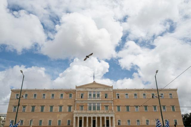 (FILES) This photograph shows a view of the Greek Parliament building on April 3, 2026. Greece's parliament on April 22, 2026 will vote on lifting the immunity of 13 lawmakers, a move demanded by European and Greek prosecutors investigating a multi-million EU farm scandal that is rocking the conservative government. Overall, the EU's European Public Prosecutor's Office (EPPO) has announced probes into 20 New Democracy ruling party members, including active and former lawmakers. (Photo by Aggelos NAKKAS / AFP)