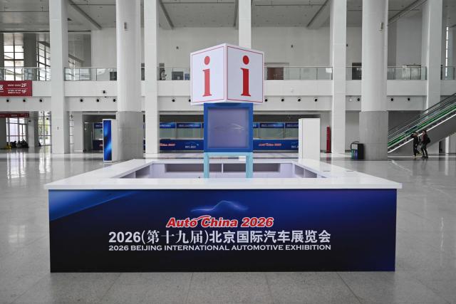 An information booth is seen ahead of the Beijing Auto Show 2026 at the China International Exhibition Center in Beijing on April 22, 2026. (Photo by Pedro PARDO / AFP)