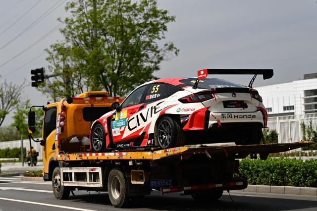 A race car from Japanese manufacturer Honda is transported towards the venue ahead of the Beijing Auto Show 2026 at the China International Exhibition Center in Beijing on April 22, 2026. (Photo by Pedro PARDO / AFP)