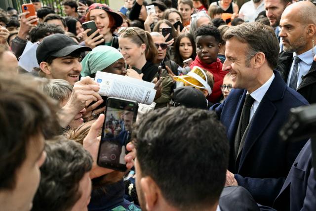 France's President Emmanuel Macron meets people as he leaves after chairing a weekly cabinet meeting in the central France city of Montluçon on April 22, 2026. (Photo by Jeff PACHOUD / AFP)