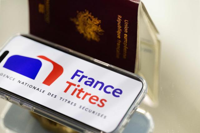 This photograph shows the France Titres logo, of the Agence Nationale des Titres Securises ANTS (France's National Agency for Secure Documents), displayed on a telephone screen in Quimper, western France, on April 22, 2026. (Photo by Fred TANNEAU / AFP)
