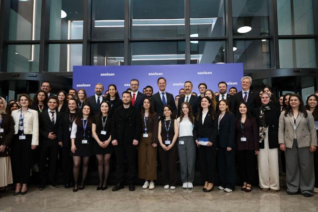 NATO Secretary General Mark Rutte (C) poses with Aselsan Defence company engineers, during his official visit to Turkey, in Ankara on April 22,2026. NATO chief Mark Rutte said the alliance would do "what's necessary to defend" its members including Turkey after intercepting four missiles fired from Iran and head into Turkish air space over the past weeks. (Photo by Adem ALTAN / AFP)