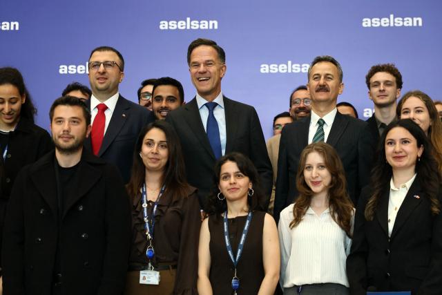 NATO Secretary General Mark Rutte (C) poses with Aselsan Defence company engineers, during his official visit to Turkey, in Ankara on April 22,2026. NATO chief Mark Rutte said the alliance would do "what's necessary to defend" its members including Turkey after intercepting four missiles fired from Iran and head into Turkish air space over the past weeks. (Photo by Adem ALTAN / AFP)