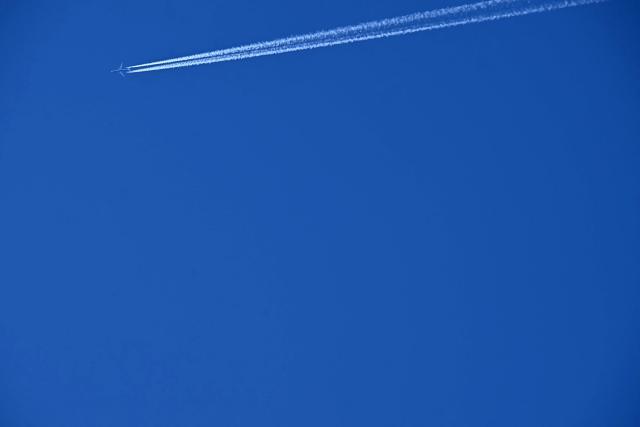 A British Airways aircraft creates vapour trails or contrails as it is flown towards London from Chicago, pictured from Liverpool, north west England on April  22, 2026. The EU unveiled on April 22 plans to address the energy crisis triggered by the war in the Middle East, including improved monitoring of jet fuel supplies as the prospect of shortages rattles Europe ahead of the summer travel season. (Photo by Paul ELLIS / AFP)
