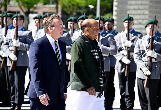 German Defence Minister Boris Pistorius (L) and his Indian counterpart Rajnath Singh review a military honor guard during a welcoming ceremony at the Defence Ministry in Berlin, on April 22, 2026. (Photo by Tobias SCHWARZ / AFP)