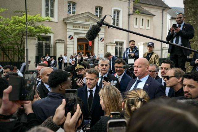France's President Emmanuel Macron meets people as he leaves after chairing a weekly cabinet meeting in the central France city of Montluçon on April 22, 2026. (Photo by Jeff PACHOUD / POOL / AFP)
