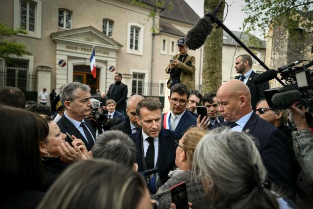 France's President Emmanuel Macron meets people as he leaves after chairing a weekly cabinet meeting in the central France city of Montluçon on April 22, 2026. (Photo by Jeff PACHOUD / POOL / AFP)