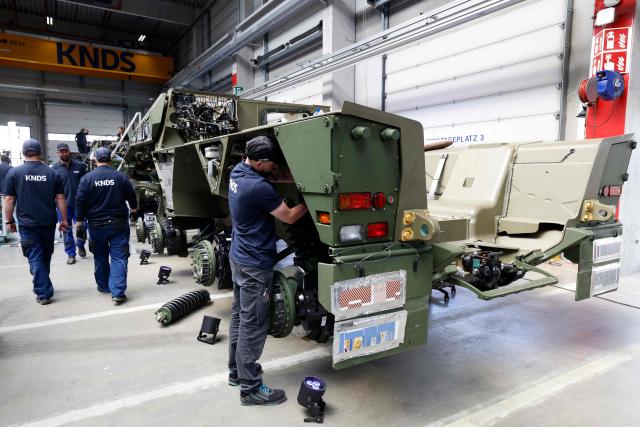 An employee works at 8x8 wheeled armoured personnel carrier Boxer during the opening of a new production line of Boxer armoured fighting vehicles produced by pan-European defense company KNDS in Munich on April 22, 2026. (Photo by Michaela STACHE / AFP)