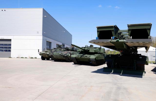Armoured vehicles produced by pan-European land defense company KNDS (L-R) Boxer, Puma, Leopard and the Leguan concept for bridging of infrastructures are pictured outside the company's production plant in Munich, southern Germany, on April 22, 2026. (Photo by Michaela STACHE / AFP)