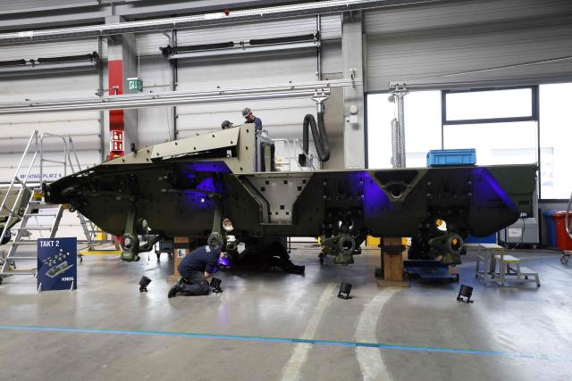 Employees work at 8x8 wheeled armoured personnel carrier Boxer during the opening of a new production line of Boxer armoured fighting vehicles produced by pan-European defense company KNDS in Munich on April 22, 2026. (Photo by Michaela STACHE / AFP)