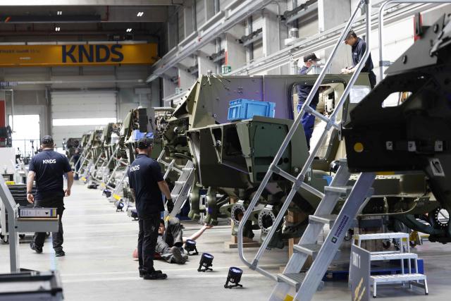 Employees work at 8x8 wheeled armoured personnel carrier Boxer during the opening of a new production line of Boxer armoured fighting vehicles produced by pan-European defense company KNDS in Munich on April 22, 2026. (Photo by Michaela STACHE / AFP)