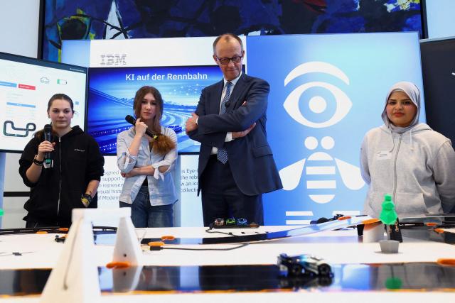 German Chancellor Friedrich Merz (2nd R) stands next to young women as he hosts the opening event of the annual "Girls' Day", a nationwide initiative empowering young women and girls to explore diverse career paths, at the Chancellery in Berlin, Germany April 22, 2026. (Photo by Lisi Niesner / POOL / AFP)