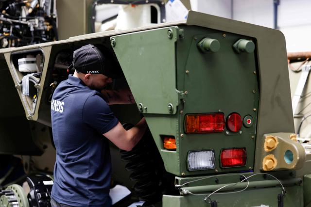 An employee works at 8x8 wheeled armoured personnel carrier Boxer during the opening of a new production line of Boxer armoured fighting vehicles produced by pan-European defense company KNDS in Munich on April 22, 2026. (Photo by Michaela STACHE / AFP)