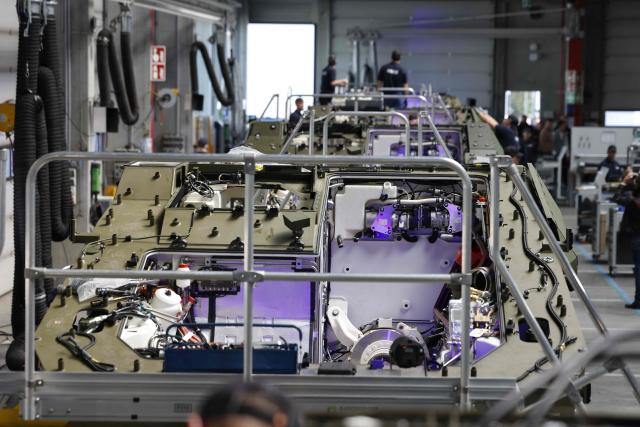 Employees work at 8x8 wheeled armoured personnel carrier Boxer during the opening of a new production line of Boxer armoured fighting vehicles produced by pan-European defense company KNDS in Munich on April 22, 2026. (Photo by Michaela STACHE / AFP)