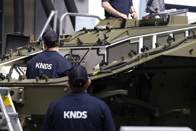 Employees work at 8x8 wheeled armoured personnel carrier Boxer during the opening of a new production line of Boxer armoured fighting vehicles produced by pan-European defense company KNDS in Munich on April 22, 2026. (Photo by Michaela STACHE / AFP)