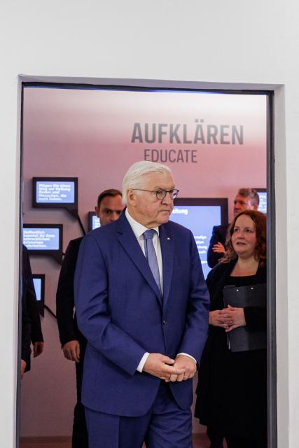 German President Frank-Walter Steinmeier (L) and Manuela Rummel, Director of Educational Programs at the Memorial, take a tour of the exhibition at the memorial site of the former Closed Youth Detention Centre (Geschlossener Jugendwerkhof Torgau - GJWH) in Torgau, eastern Germany on April 22, 2026. According to the memorial site, the closed youth detention centre used to be the only closed residential care facility in the GDR, where young people were to be re-educated into "socialist personalities" within just a few months. During the course of GDR history, approximately 135,000 children and young people were forced to go through socialist re-education practices in youth work camps and special children's homes. Historical traces at the memorial site are visible in the former solitary confinement cells and courtyard. (Photo by Jens SCHLÜTER / POOL / AFP)