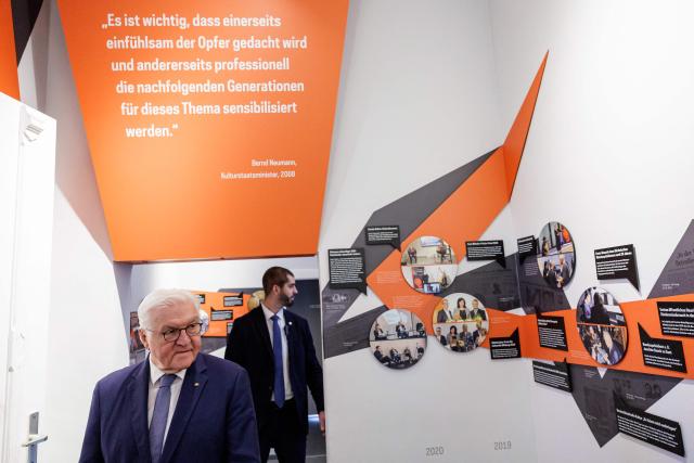 German President Frank-Walter Steinmeier discovers the exhibition during his visit of the memorial site of the former Closed Youth Detention Centre (Geschlossener Jugendwerkhof Torgau - GJWH) in Torgau, eastern Germany on April 22, 2026. According to the memorial site, the closed youth detention centre used to be the only closed residential care facility in the GDR, where young people were to be re-educated into "socialist personalities" within just a few months. During the course of GDR history, approximately 135,000 children and young people were forced to go through socialist re-education practices in youth work camps and special children's homes. Historical traces at the memorial site are visible in the former solitary confinement cells and courtyard. (Photo by Jens SCHLÜTER / POOL / AFP)