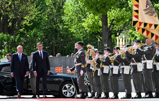 North Macedonian Prime Minister Hristijan Mickoski (2nd L) and Austrian Chancellor Christian Stocker (L) review a military honour guard at the Federal Chancellery in Vienna on April 22, 2026. (Photo by HELMUT FOHRINGER / APA / AFP) / Austria OUT