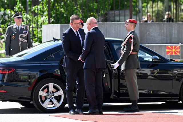 North Macedonian Prime Minister Hristijan Mickoski (L) is welcomed by Austrian Chancellor Christian Stocker at the Federal Chancellery in Vienna on April 22, 2026. (Photo by HELMUT FOHRINGER / APA / AFP) / Austria OUT