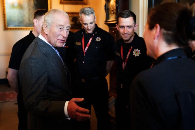 Britain's King Charles III meets members from the Scottish Fire and Rescue Service who assisted in managing the Glasgow Central Station fire, at Dumfries House near Cumnock, south of Glasgow, Scotland on April 22, 2026. (Photo by Jane Barlow / POOL / AFP)