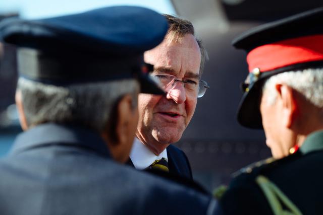 German Defence Minister Boris Pistorius (C) speaks to members of the Indian navy as he visits the TKMS (ThyssenKrupp Marine Systems) submarine shipyard with his Indian counterpart in Kiel, northern Germany on April 22, 2026. (Photo by Gregor Fischer / AFP)