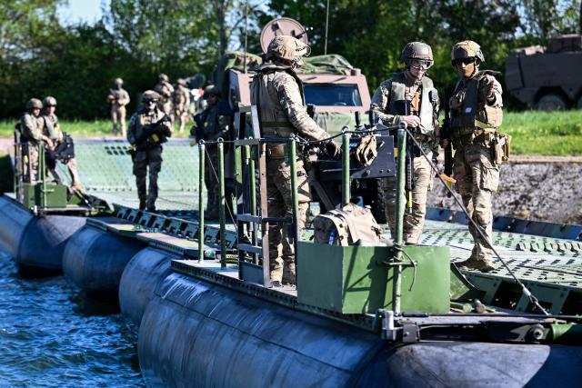 Members of France's 1st Tirailleur Regiment cross Lake Amance, during a training session as part of the ORION 26 military exercise in Radonvilliers, northeastern France, on April 22, 2026. (Photo by Jean-Christophe VERHAEGEN / AFP)