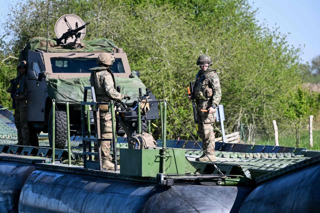 Members of France's 1st Tirailleur Regiment cross Lake Amance, during a training session as part of the ORION 26 military exercise in Radonvilliers, northeastern France, on April 22, 2026. (Photo by Jean-Christophe VERHAEGEN / AFP)