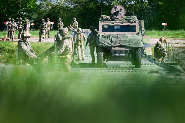 Members of France's 1st Tirailleur Regiment cross Lake Amance, during a training session as part of the ORION 26 military exercise in Radonvilliers, northeastern France, on April 22, 2026. (Photo by Jean-Christophe VERHAEGEN / AFP)