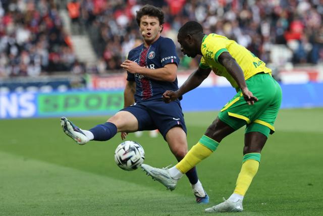 Nantes' Colombian defender #27 Deiver Machado (R) shoots the ball past Paris Saint-Germain's Portuguese midfielder #87 Joao Neves during the French L1 football match between Paris Saint-Germain (PSG) and FC Nantes at the Parc des Princes stadium in Paris on April 22, 2026. (Photo by FRANCK FIFE / AFP)