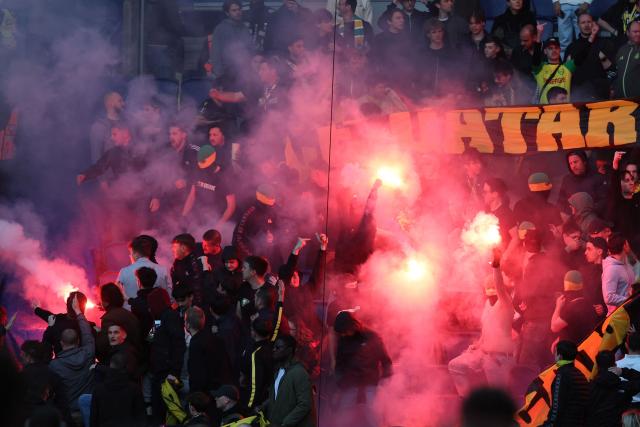 Paris Saint-Germain's supporters light flares as they celebrate team's first goal during the French L1 football match between Paris Saint-Germain (PSG) and FC Nantes at the Parc des Princes stadium in Paris on April 22, 2026. (Photo by FRANCK FIFE / AFP)