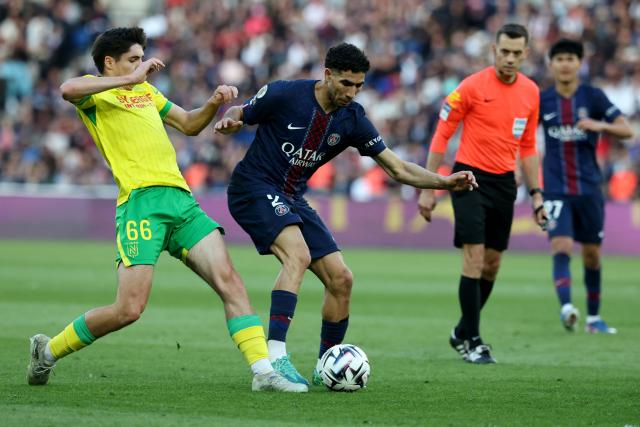Nantes' French midfielder #66 Louis Leroux (L) fights for the ball with Paris Saint-Germain's Moroccan defender #02 Achraf Hakimi (2nd L) during the French L1 football match between Paris Saint-Germain (PSG) and FC Nantes at the Parc des Princes stadium in Paris on April 22, 2026. (Photo by FRANCK FIFE / AFP)