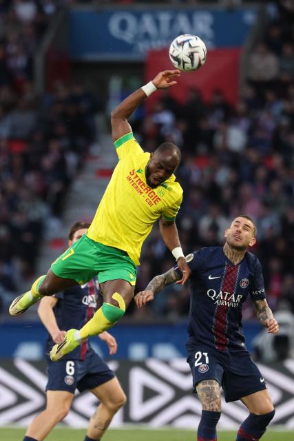 Nantes' Cameroonian forward #37 Ignatius Ganago (L) fights for the ball with Paris Saint-Germain's French defender #21 Lucas Hernandez during the French L1 football match between Paris Saint-Germain (PSG) and FC Nantes at the Parc des Princes stadium in Paris on April 22, 2026. (Photo by FRANCK FIFE / AFP)