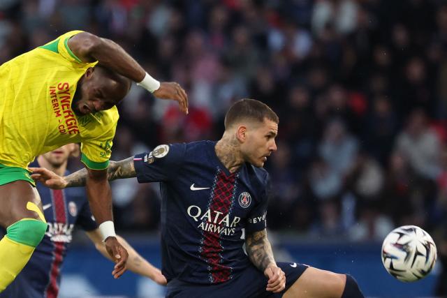 Nantes' Cameroonian forward #37 Ignatius Ganago (L) fights for the ball with Paris Saint-Germain's French defender #21 Lucas Hernandez during the French L1 football match between Paris Saint-Germain (PSG) and FC Nantes at the Parc des Princes stadium in Paris on April 22, 2026. (Photo by FRANCK FIFE / AFP)