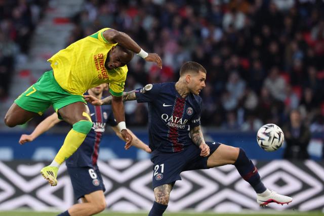 Nantes' Cameroonian forward #37 Ignatius Ganago (L) fights for the ball with Paris Saint-Germain's French defender #21 Lucas Hernandez during the French L1 football match between Paris Saint-Germain (PSG) and FC Nantes at the Parc des Princes stadium in Paris on April 22, 2026. (Photo by FRANCK FIFE / AFP)