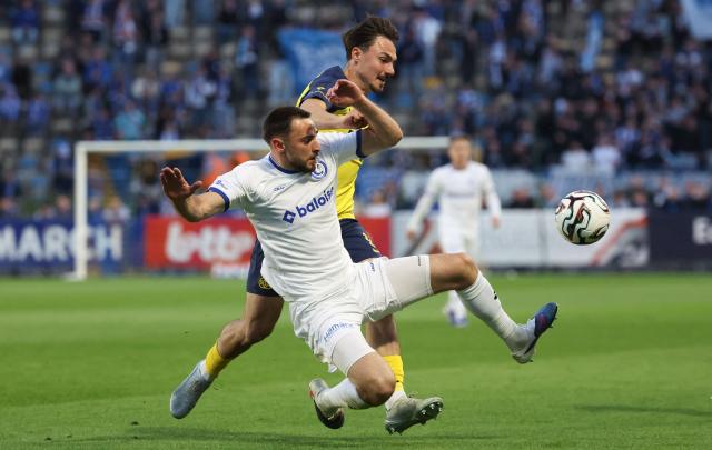 KAA Gent's Belgian defender #57 Matties Volckaert fights for the ball with Royale Union Saint-Gilloise's German forward #09 Mateo Biondic during the fourth day of the Champion's Play-offs of the 2025-2026 Belgian championship Pro League first division football match between Royale Union Saint-Gilloise (RUSG) and and KAA Gent at the Joseph Marien Stadium in Brussels on April 22, 2026. (Photo by VIRGINIE LEFOUR / BELGA / AFP) / Belgium OUT