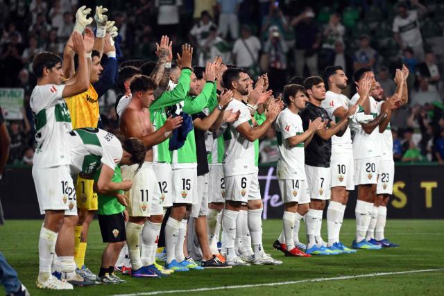 Elche players celebrate their victory at the end of the Spanish league football match between Elche CF and Club Atletico Madrid at Martinez Valero Stadium in Elche on April 22, 2026. (Photo by JOSE JORDAN / AFP)