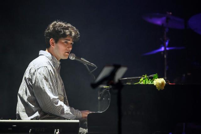Swiss singer Gjon's Tears performs during a tribute concert entitled “Au cњur de Crans” for the victims of the New Year’s Eve bar fire in Crans-Montana, at the Salle Mйtropole in Lausanne on April 22, 2026. The fire that broke out in the bar "Le Constellation" during New Year celebrations, claimed 41 lives, most of them teenagers, and injured 115 others. (Photo by Fabrice COFFRINI / AFP)