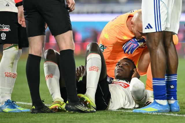 Nice's Sierra Leonean defender #28 Juma Bah lies injured on the pitch during the French Cup semi-final football match between RC Strasbourg Alsace and OGC Nice at the Stade de la Meinau in Strasbourg, eastern France, on April 22, 2026. (Photo by SEBASTIEN BOZON / AFP)