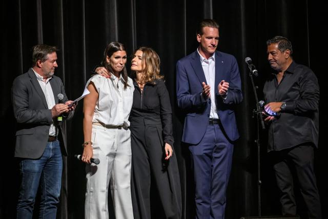 (From L) Founder and president of Swisshearts association Stephane Buchs, Laetitia Brodard-Sitre mother of Arthur who died in the fire, co-organizer of the concert Corinne Uzan, Hugues Blatti, father of Luka Blatti, who was severely burned and co-organizer of the concert Olivier Uzan stand on stand at the start of a tribute concert entitled “Au cњur de Crans” for the victims of the New Year’s Eve bar fire in Crans-Montana, at the Salle Mйtropole in Lausanne on April 22, 2026. The fire that broke out in the bar "Le Constellation" during New Year celebrations, claimed 41 lives, most of them teenagers, and injured 115 others. (Photo by Fabrice COFFRINI / AFP)