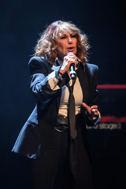 French pop and jazz singer Julie Pietri performs during a tribute concert entitled “Au cњur de Crans” for the victims of the New Year’s Eve bar fire in Crans-Montana, at the Salle Mйtropole in Lausanne on April 22, 2026. The fire that broke out in the bar "Le Constellation" during New Year celebrations, claimed 41 lives, most of them teenagers, and injured 115 others. (Photo by Fabrice COFFRINI / AFP)