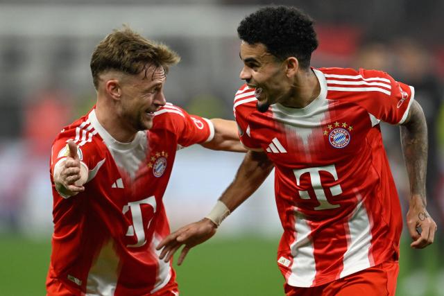 Bayern Munich's Colombian forward #14 Luis Diaz celebrates scoring the 0-2 goal with his teammate Bayern Munich's German midfielder #06 Joshua Kimmich during the German Cup (DFB-Pokal) semi-final football match between Bayer 04 Leverkusen and FC Bayern Munich in Leverkusen, western Germany on April 22, 2026. (Photo by INA FASSBENDER / AFP) / DFB REGULATIONS PROHIBIT ANY USE OF PHOTOGRAPHS AS IMAGE SEQUENCES AND QUASI-VIDEO.